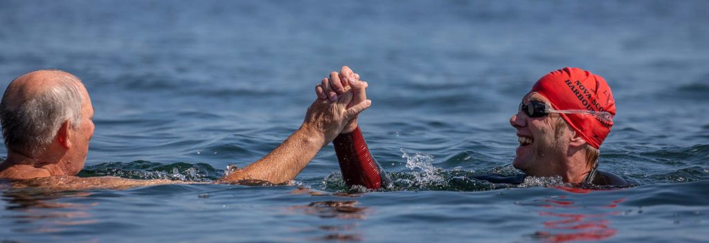 Swimmers high-fiving in the Halifax Harbour