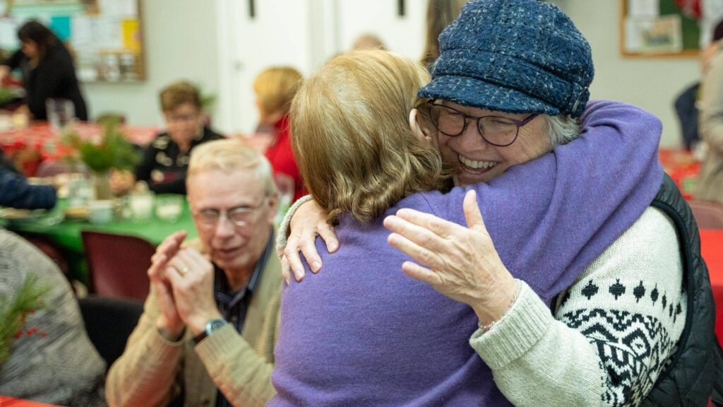 Two people hug at a United Way event.