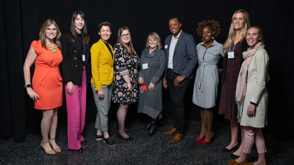 Group photo of United Way staff with a black background