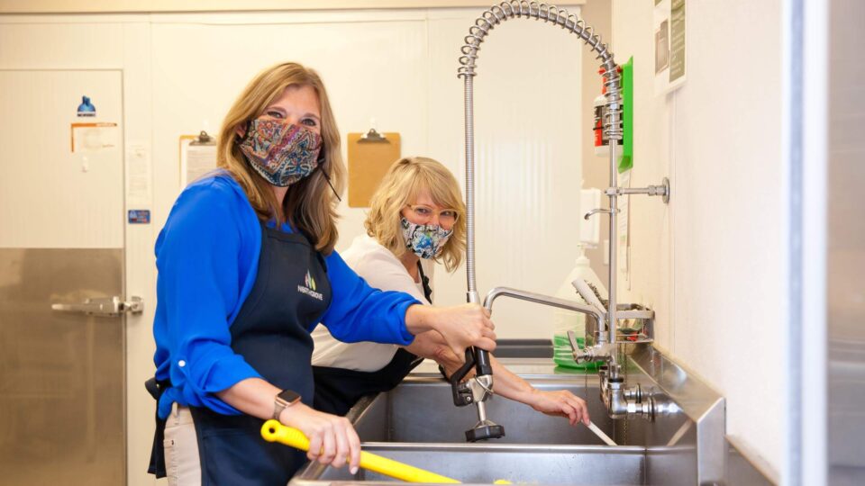 United Way Halifax staff using dishwashing equipment
