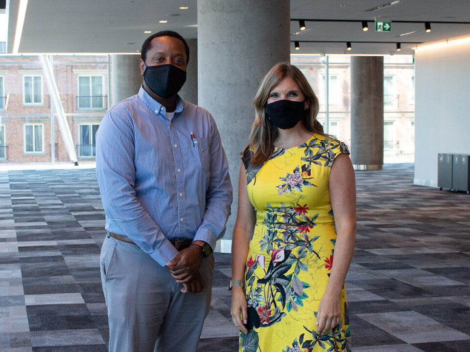 Board chair Kenny Hilaire and CEO Sara Napier stand in the atrium of the Halifax Convention Centre