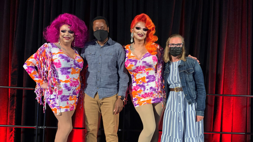 Board members stand with drag queens Deva Station and Dyna Might