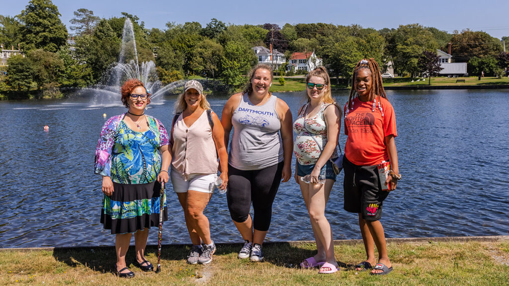 Group of women standing in front of Sullivan's Pond