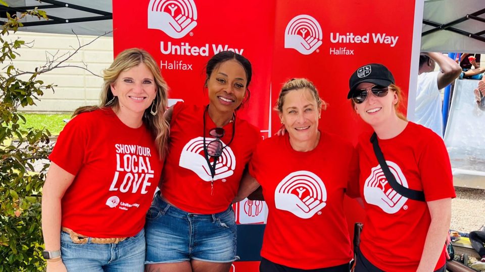 Group of four people wearing red united way shirts