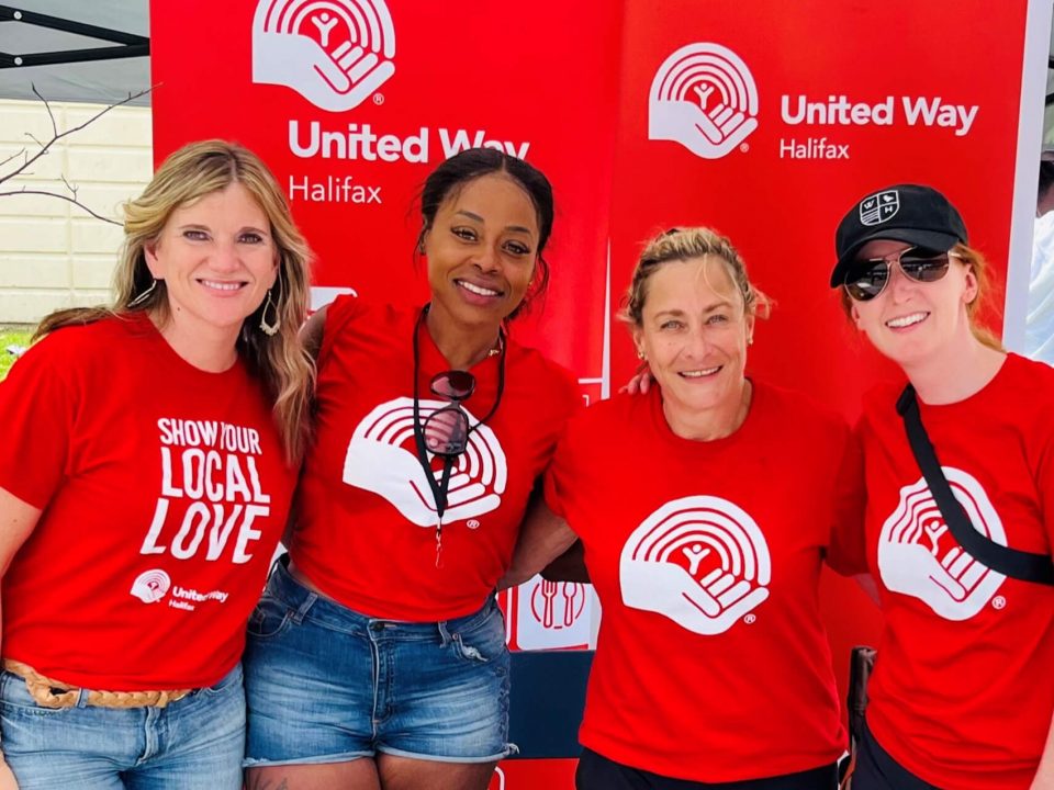 Group of four people wearing red united way shirts