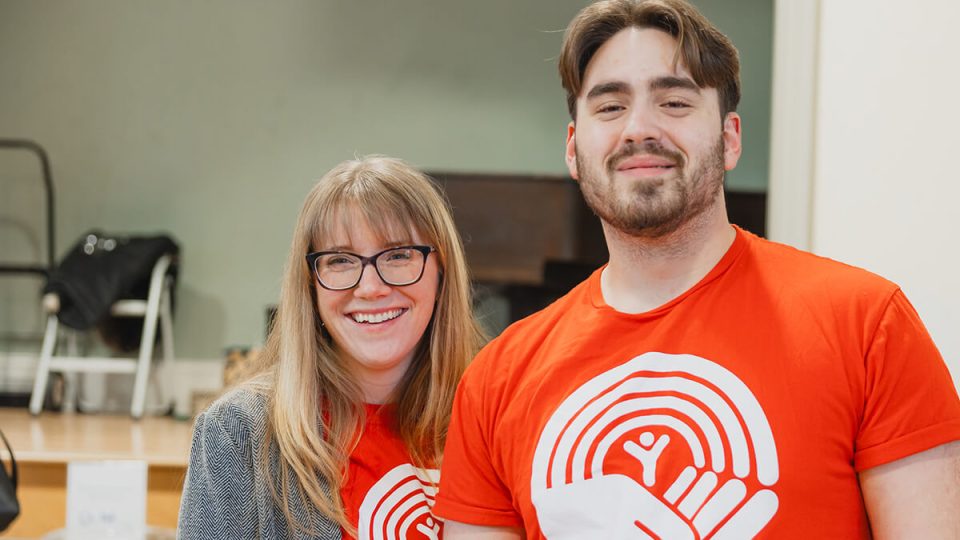 Woman and a man in red United Way shirts