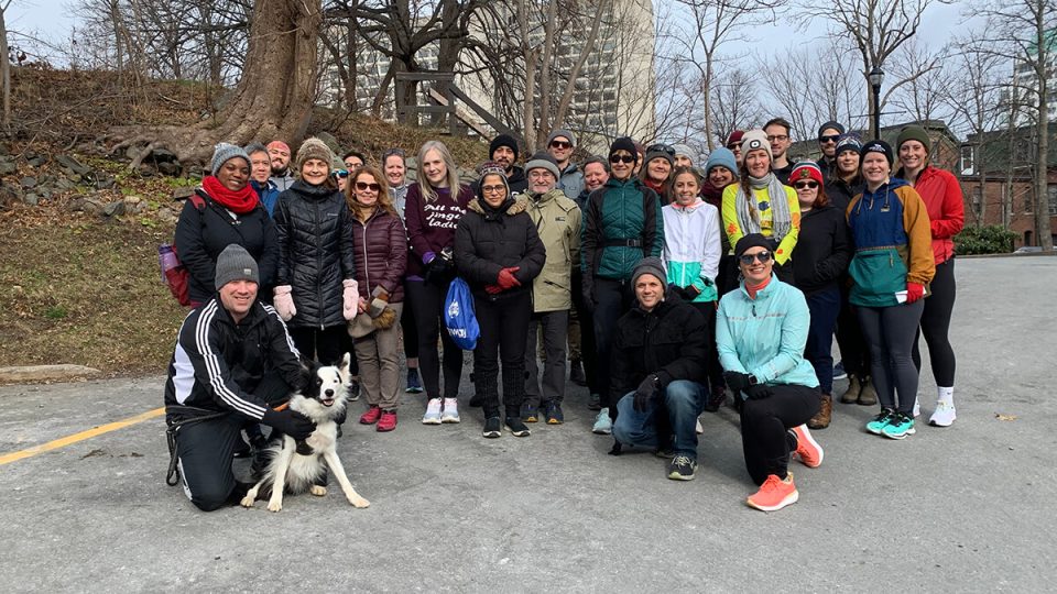 Group of United Way Maritimes staff, volunteers and a dog outdoors in the winter