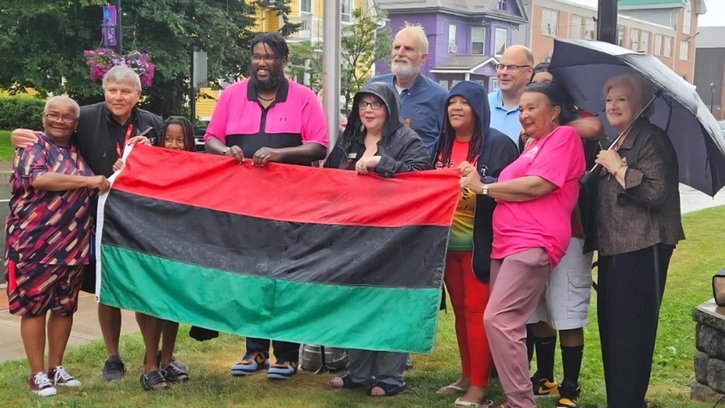 Recognizing Emancipation Day with a flag raising