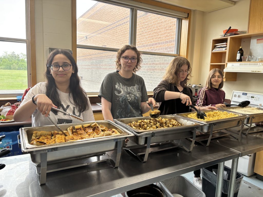 A group of high school students serving food