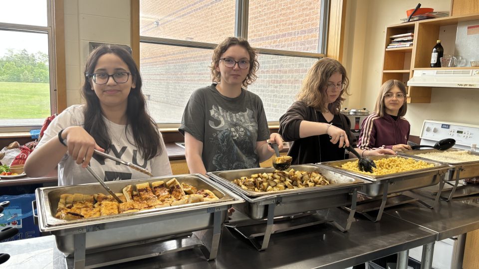 A group of high school students serving food
