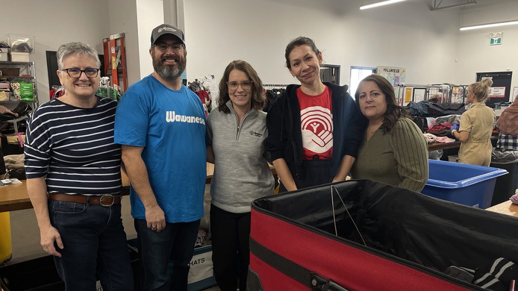 Wawanesa participated in a Day of Caring, learning about community needs while sorting donated clothes for distribution.