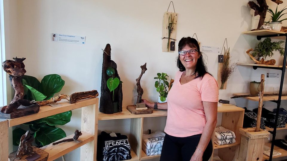 A woman standing amongst shelves of handmade creations