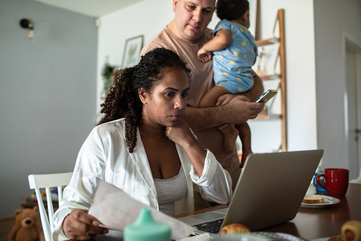 A couple with a baby looking at their finances